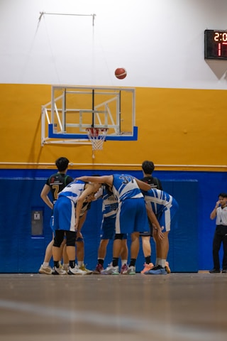 Basketball team huddling before the game starts.