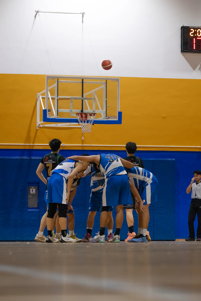 Basketball team huddling together before the game starts