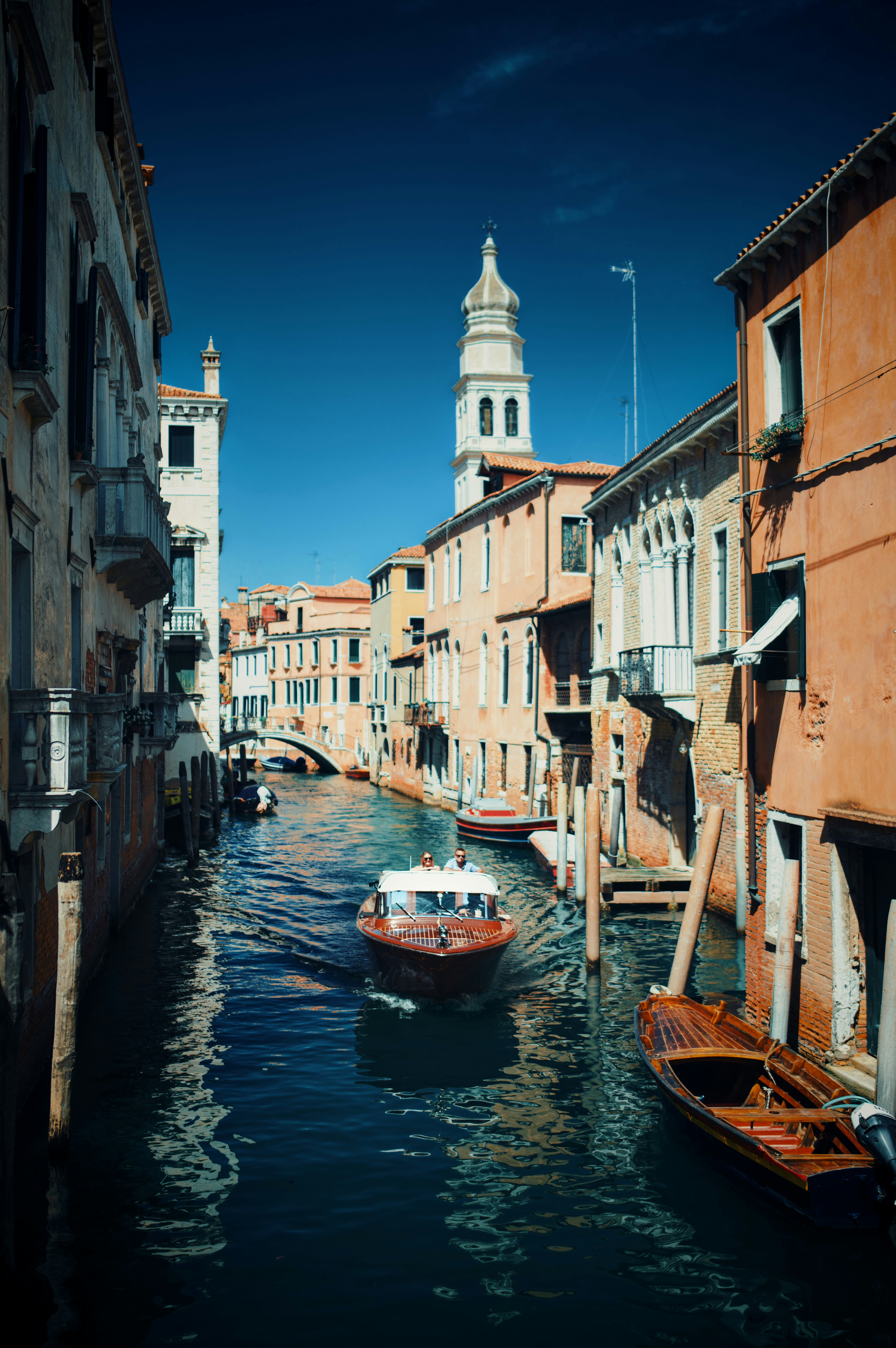 Boat on a canal in venice with historic buildings
