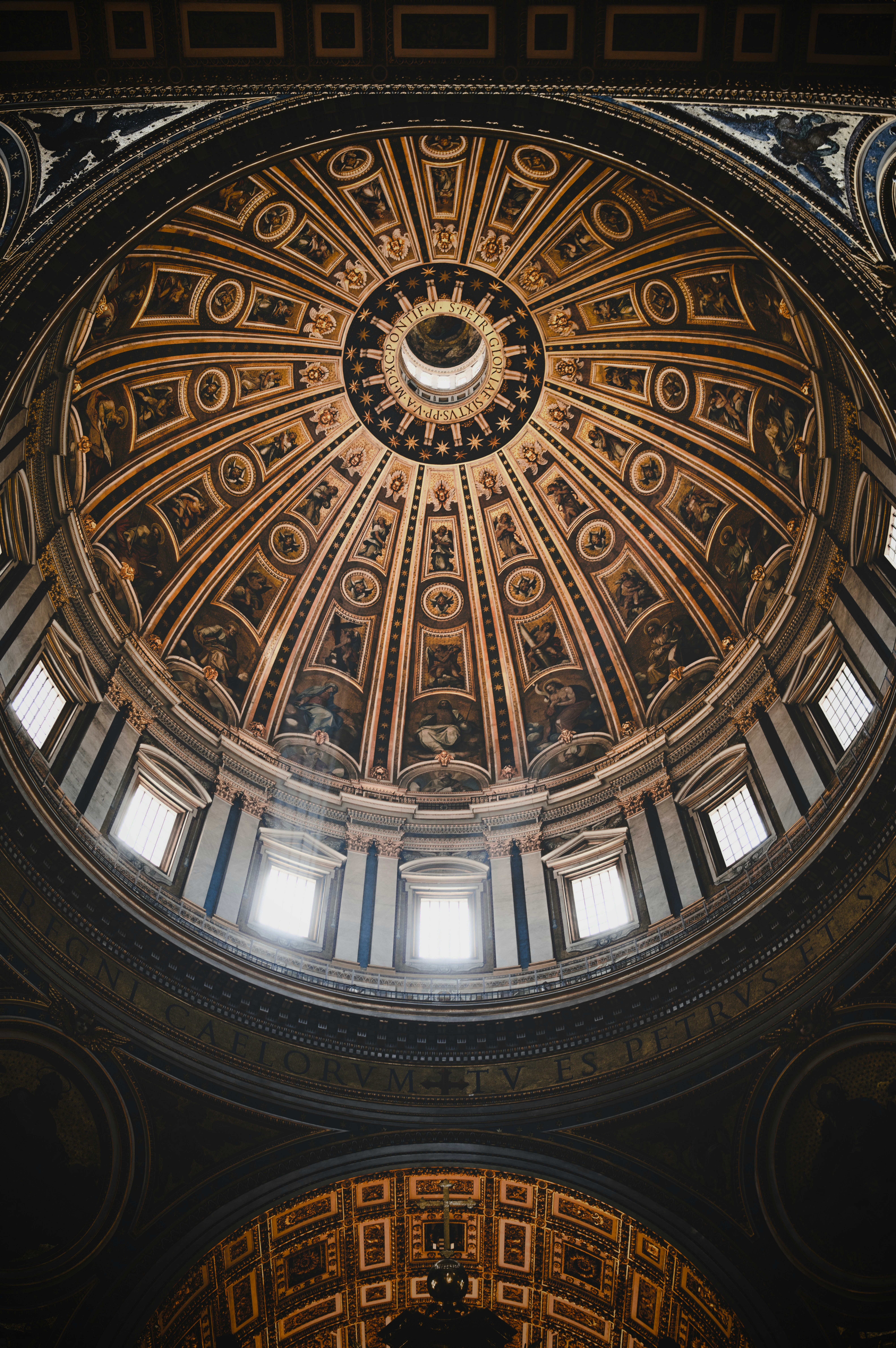 Ornate dome interior with natural light filtering in.