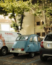 A vintage blue car parked outdoors.