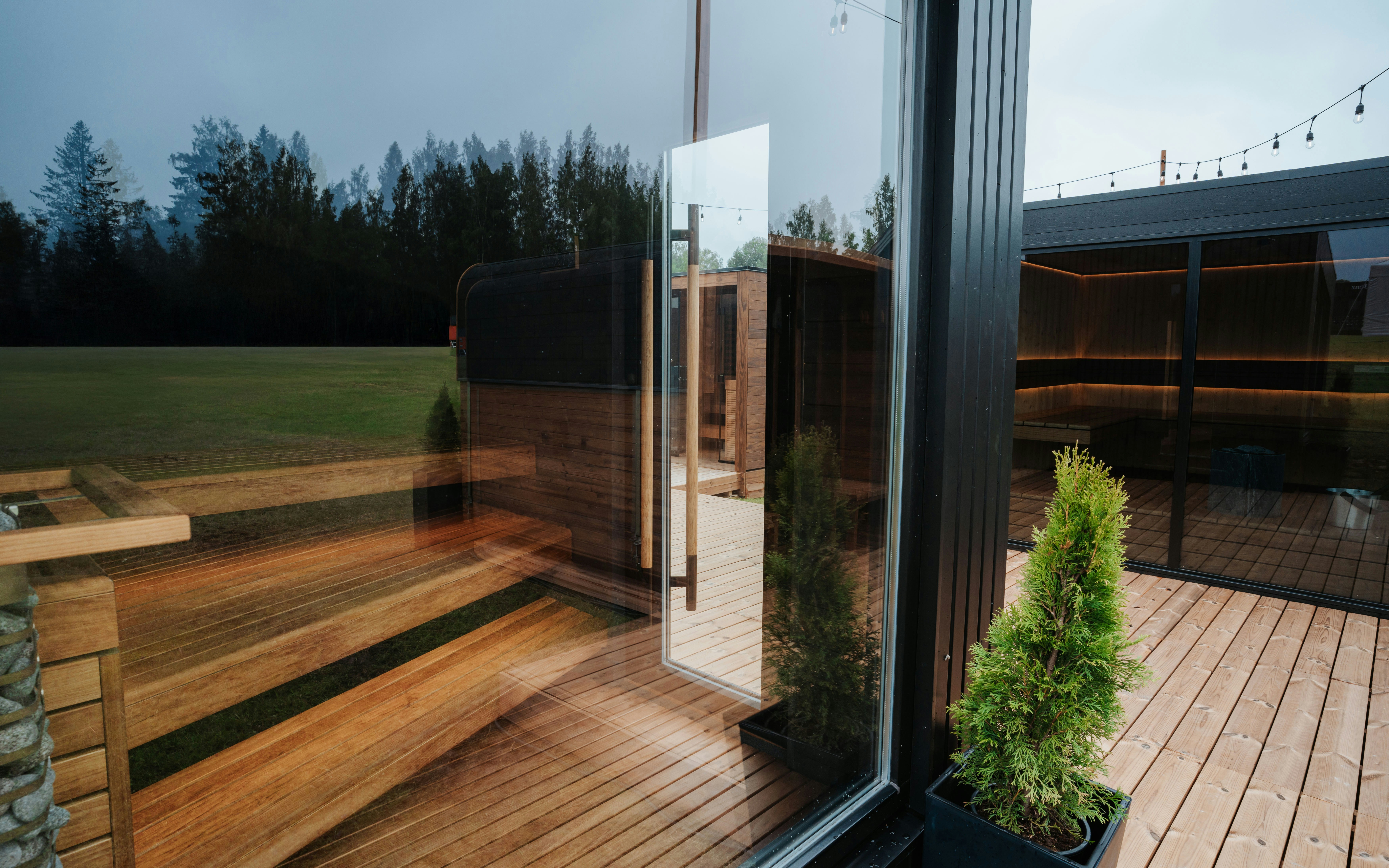 Modern sauna cabins with glass walls and warm wooden interiors