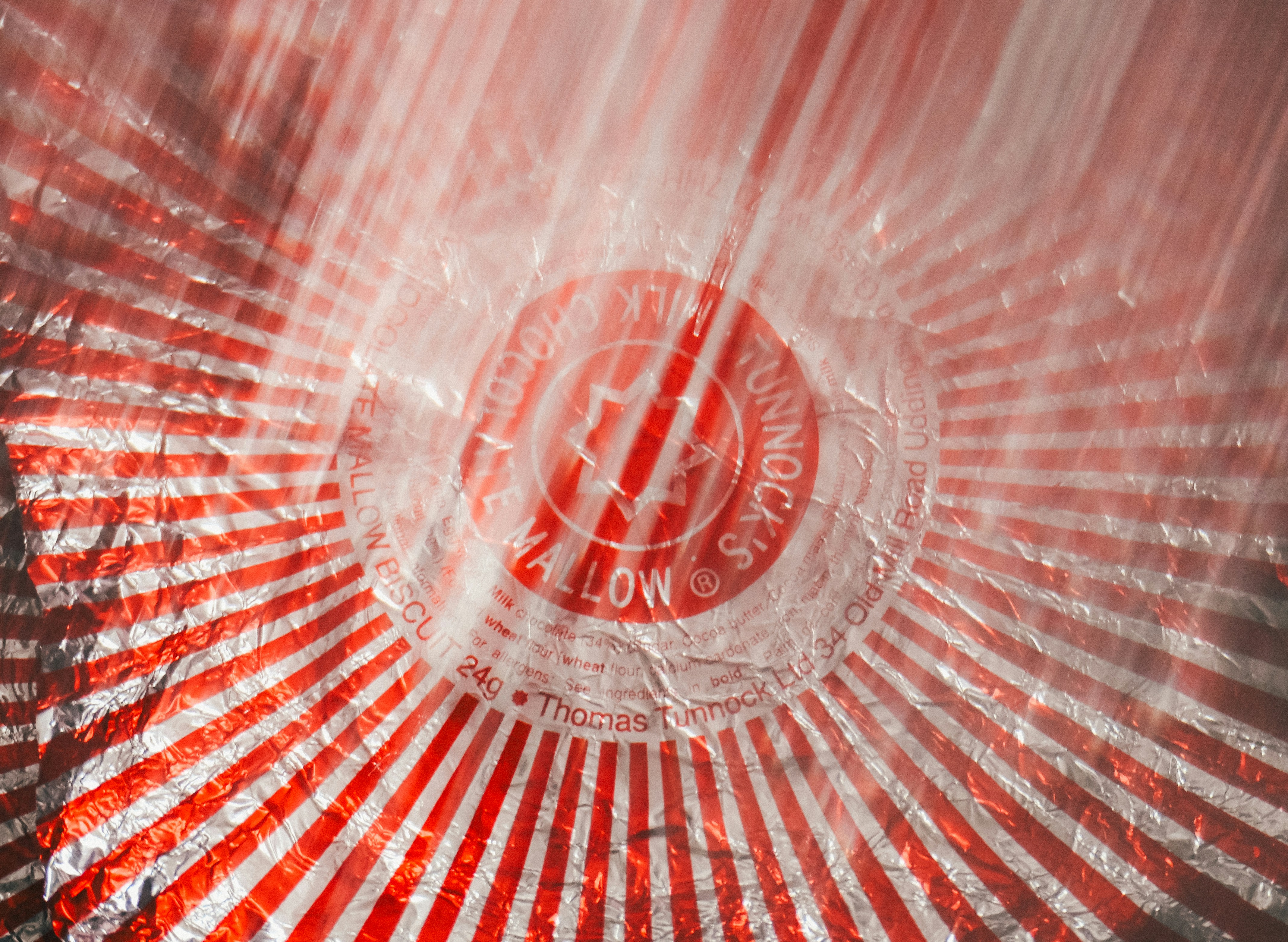 Red and white striped surface with a circular emblem.