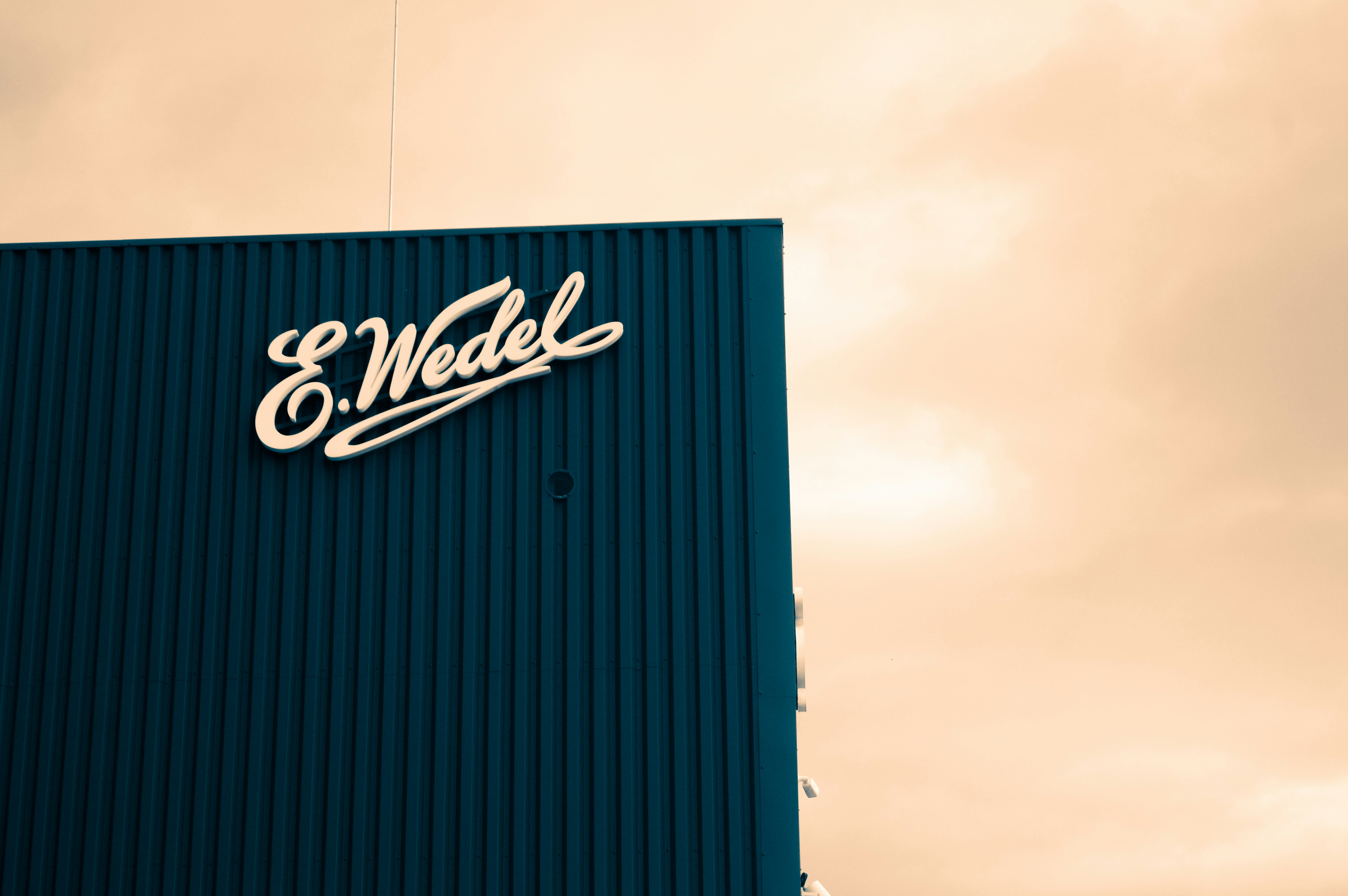 E. wedel logo on a blue building facade