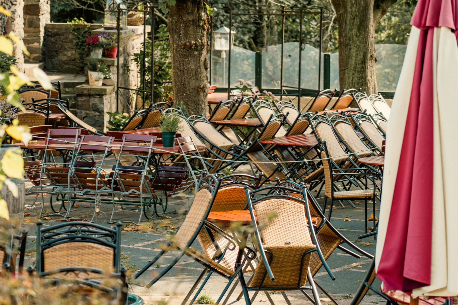 Chairs and tables stacked up at an outdoor cafe