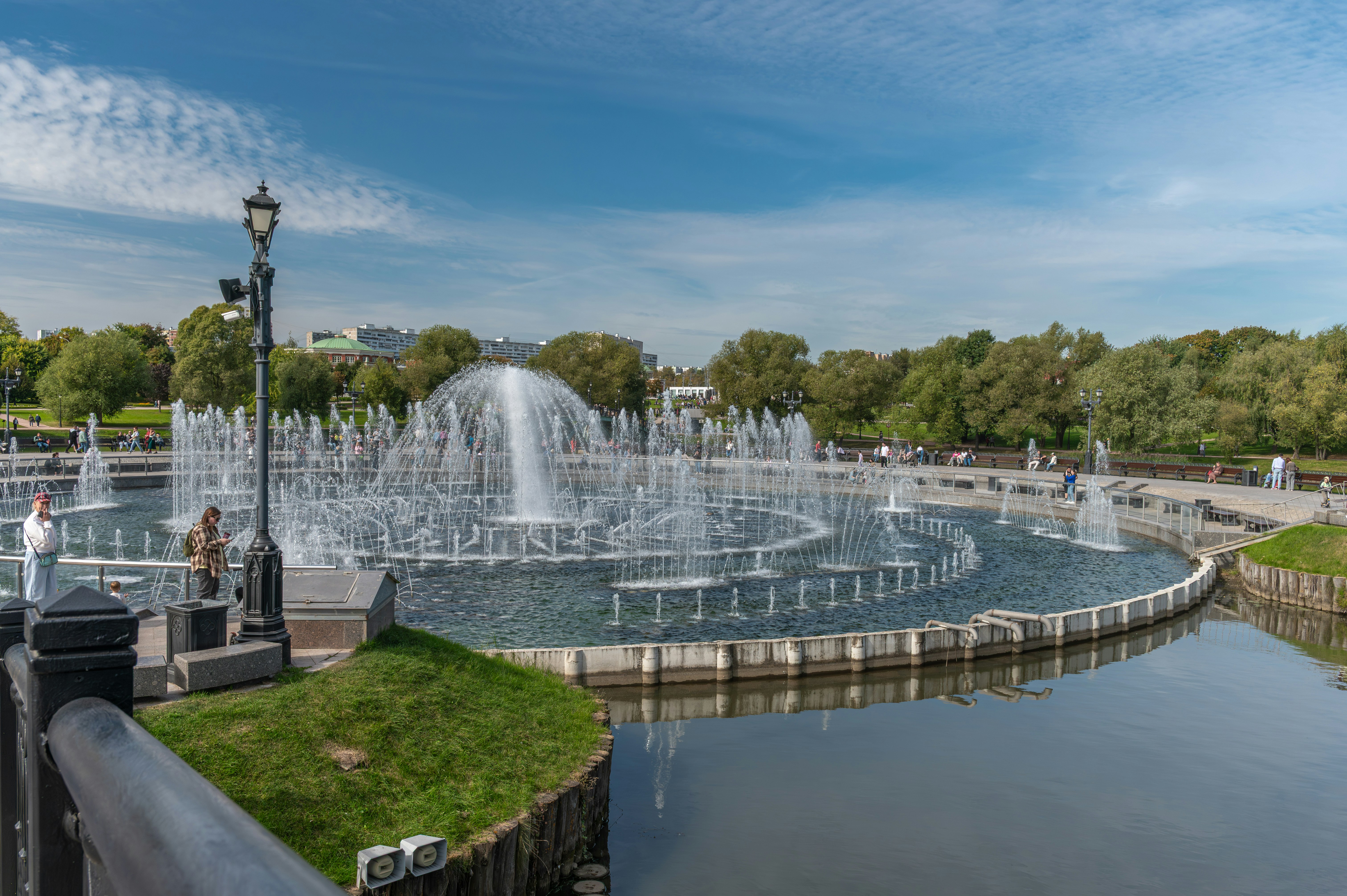 A large fountain spraying water in a park.