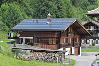 Wooden house with solar panels in a green landscape