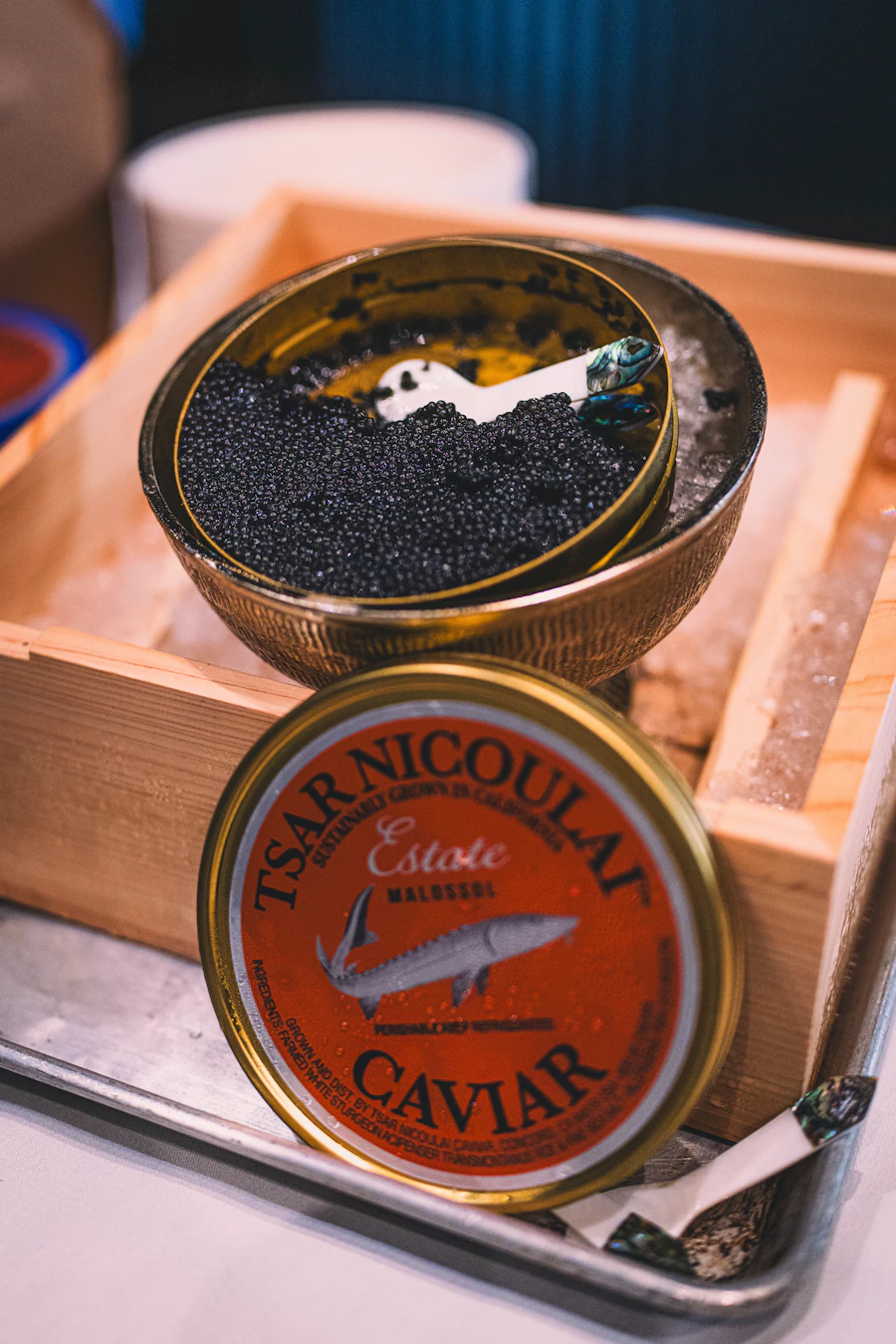 A mother-of-pearl caviar service on crushed ice