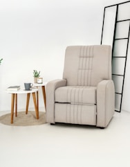 A beige recliner chair with a small side table.