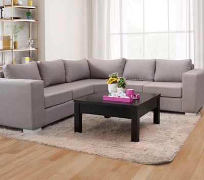 A sectional sofa with a coffee table in a room.