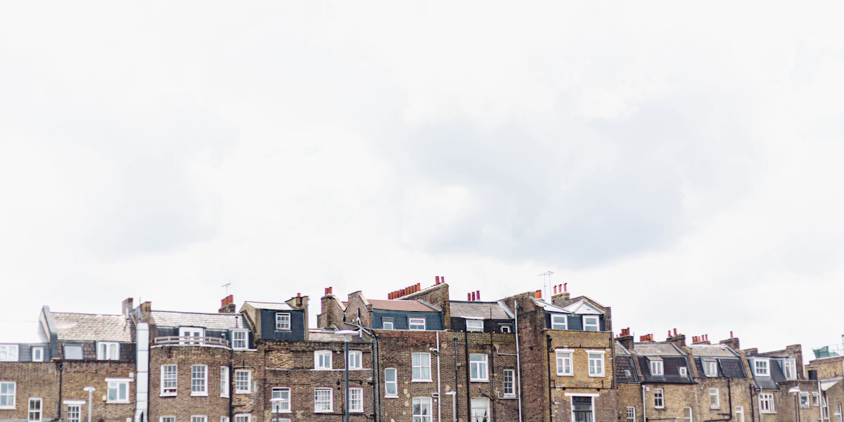 A row of old brick houses under an overcast sky