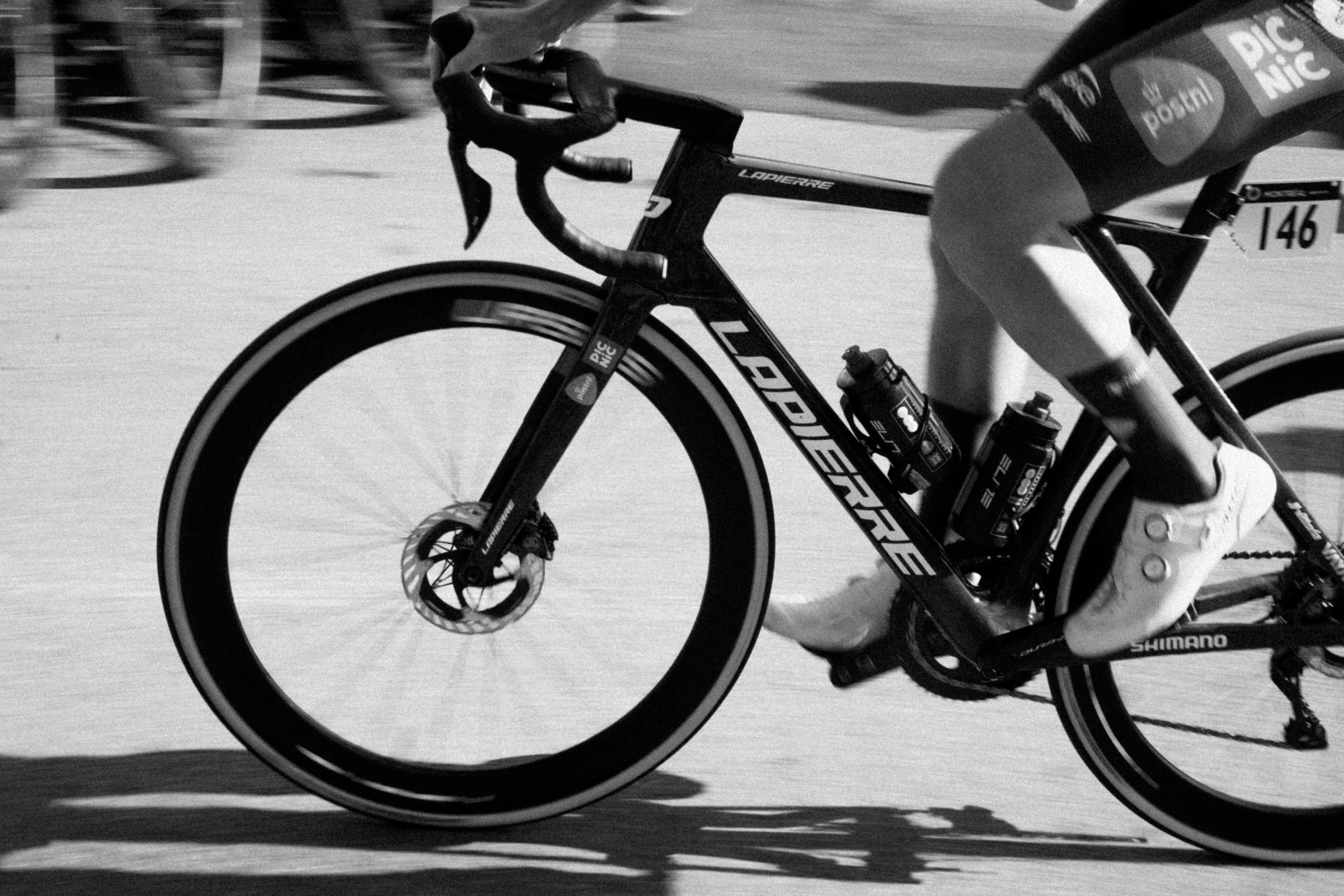 Cyclist riding a road bike with water bottles.