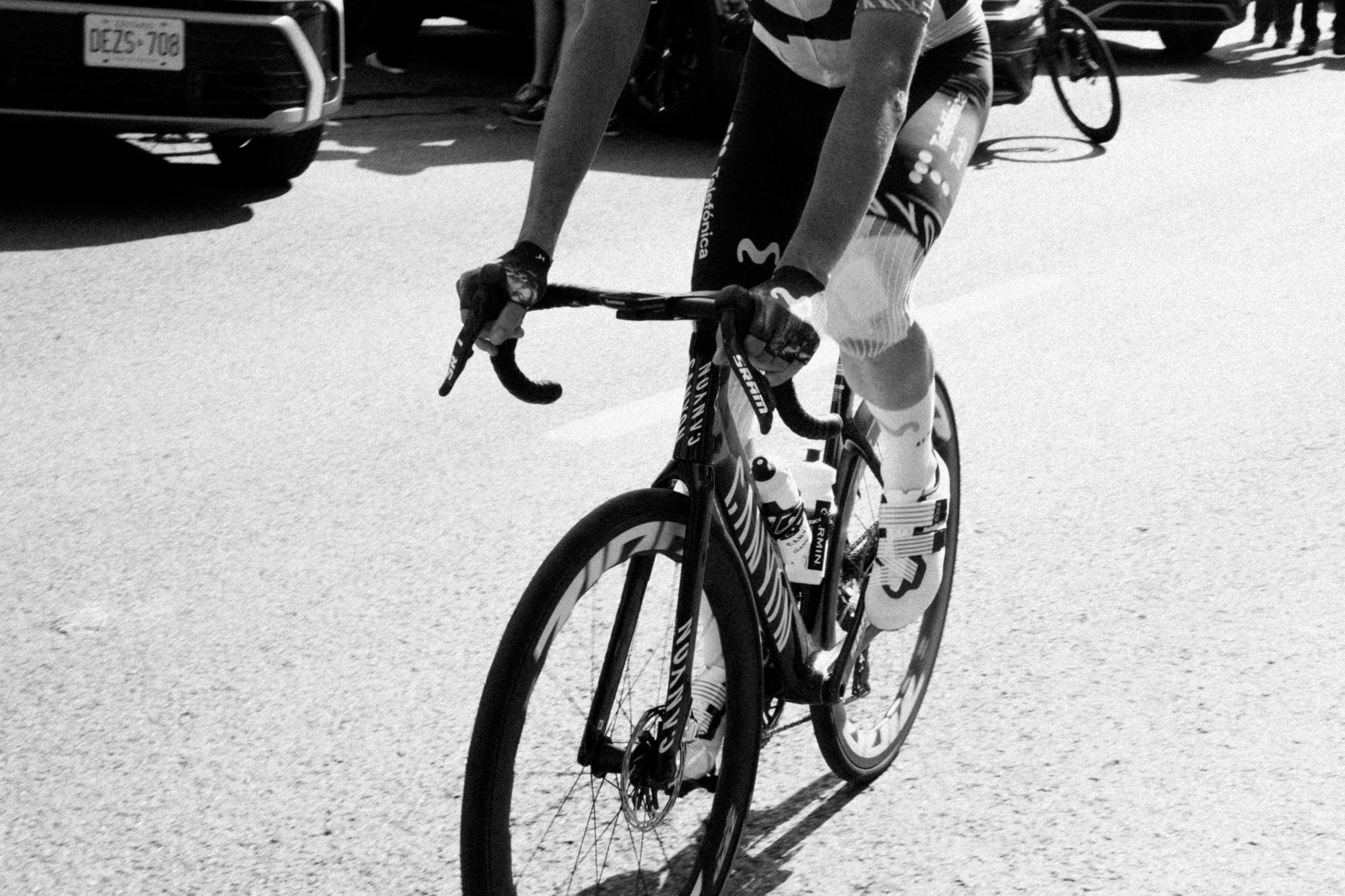 Cyclist riding a bicycle on a paved road.