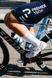 Cyclist's legs in motion on a racing bicycle.