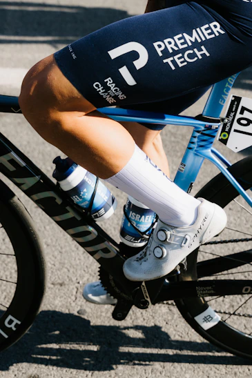 Cyclist's legs in motion on a racing bicycle.