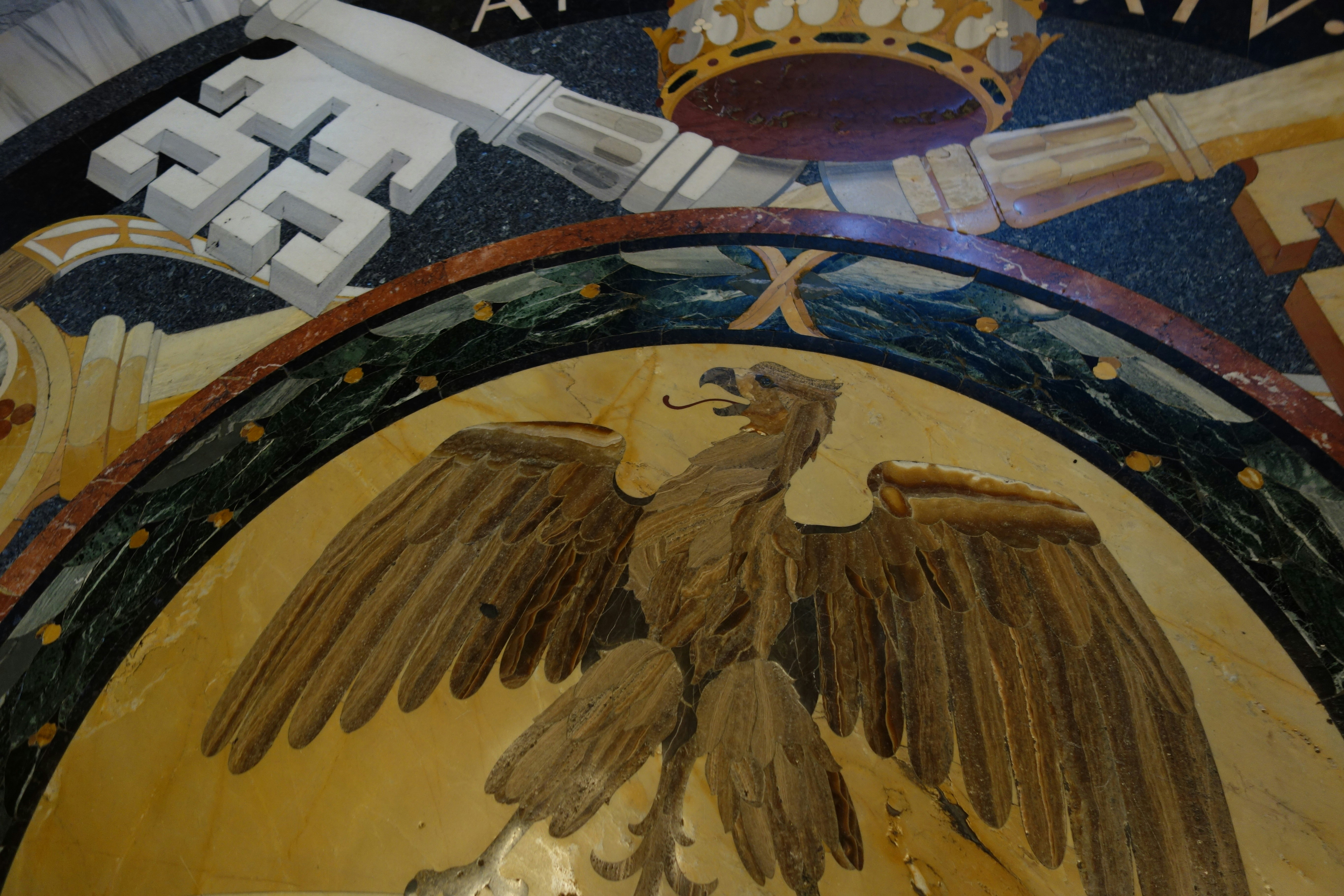 Eagle mosaic with keys and crown above