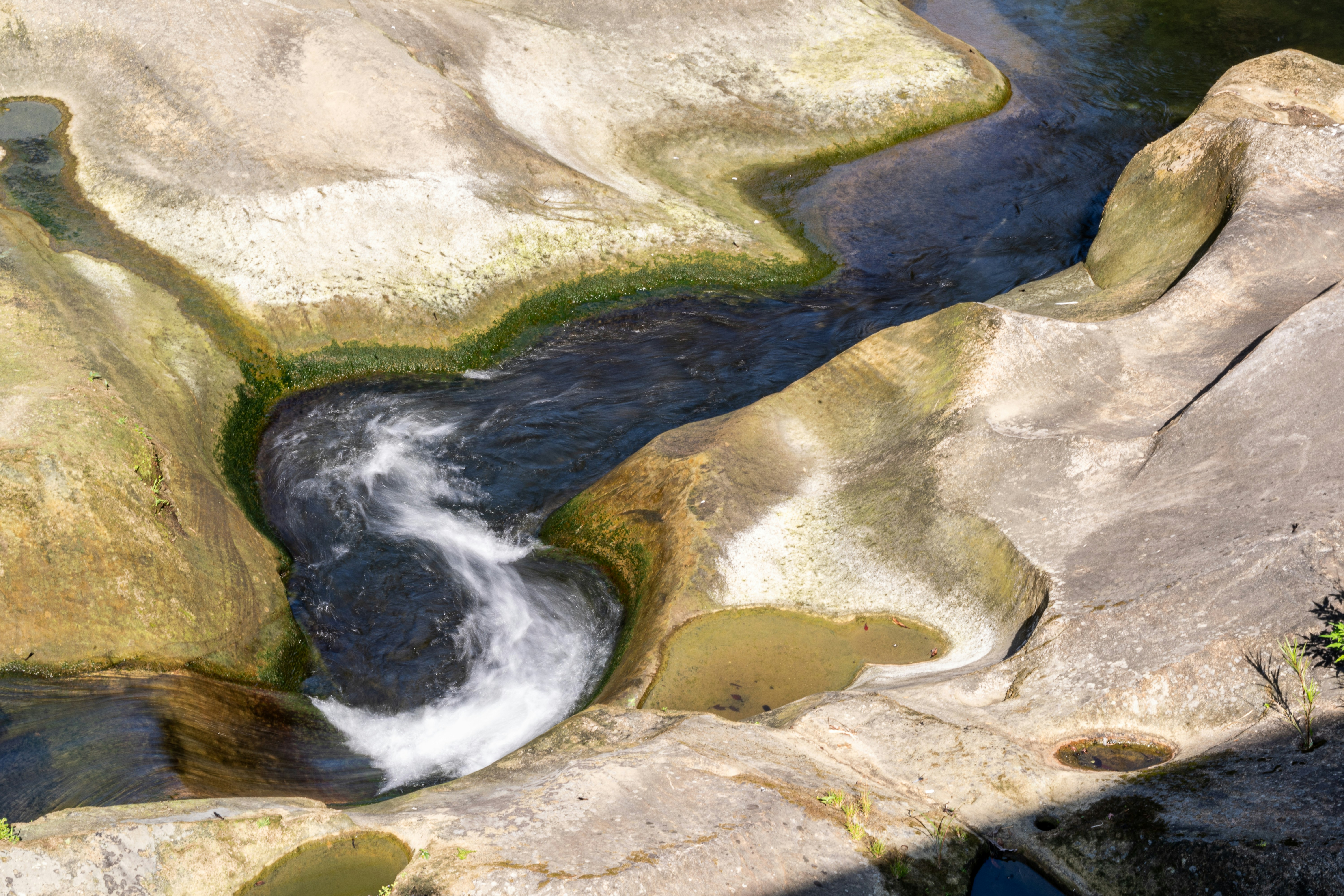 Water flows through carved rock formations