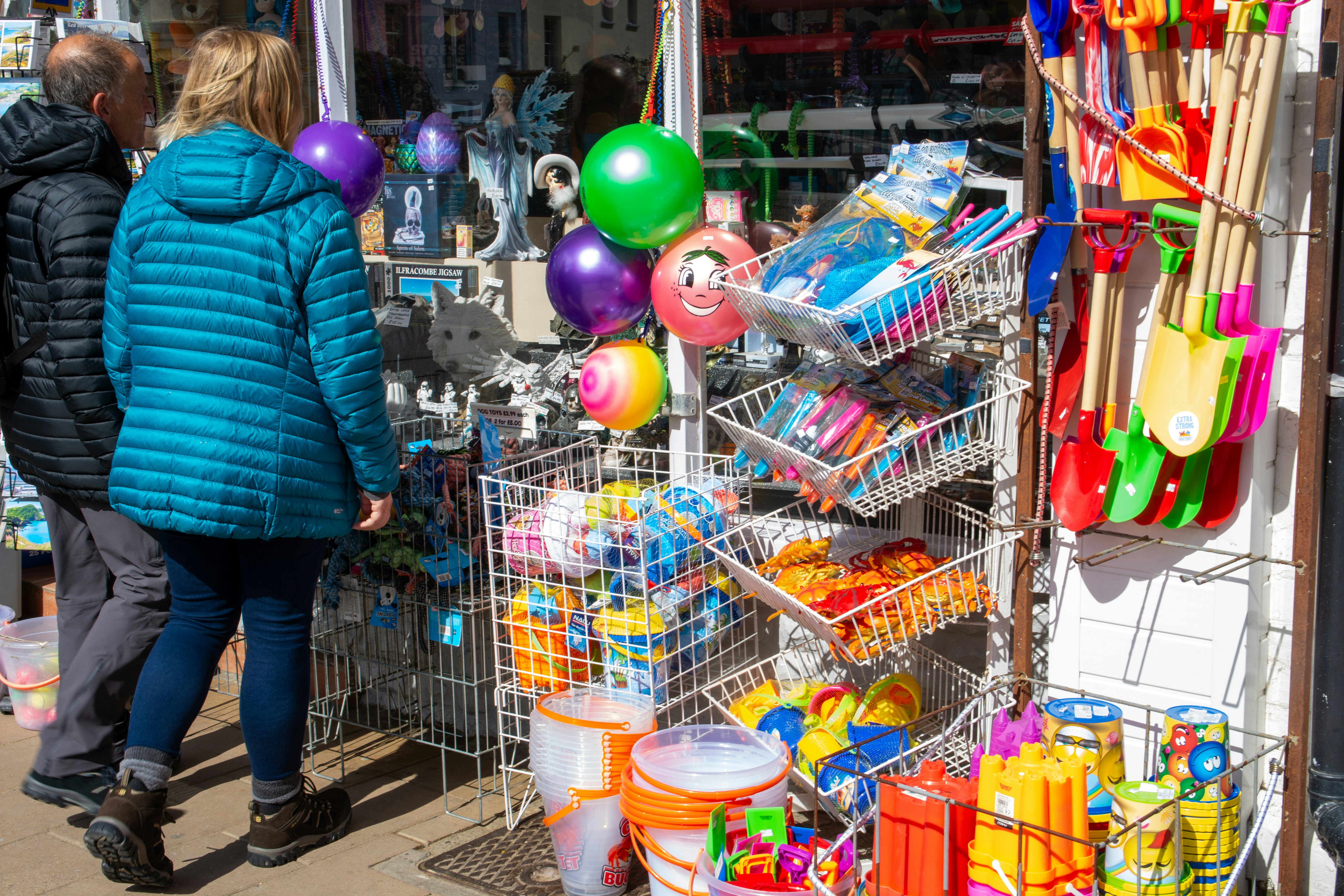 People browse beach toys outside a store