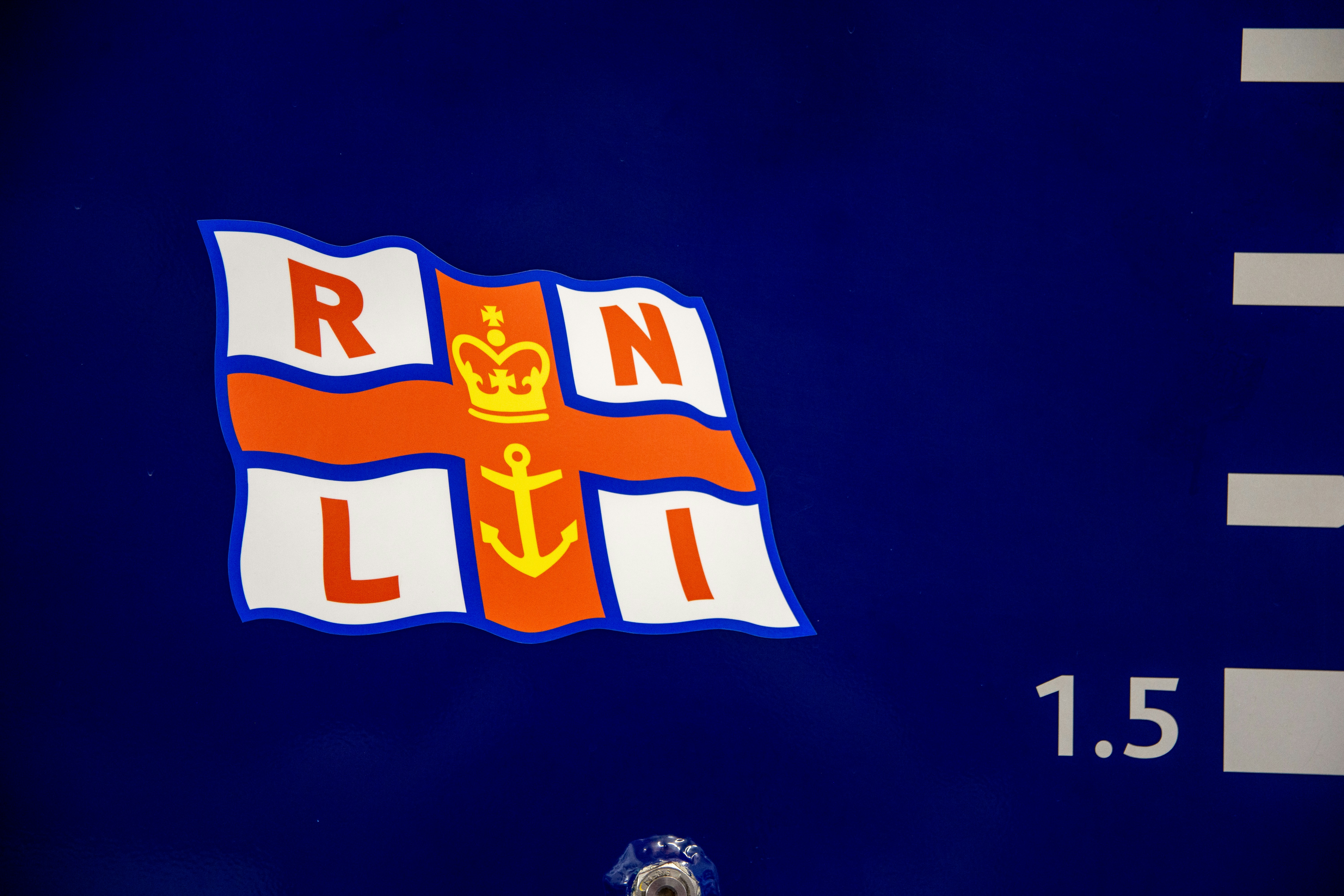 Rnli flag on a blue surface with markings.