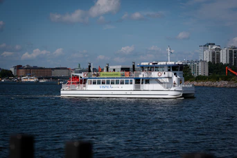 A white ferry boat sailing on the water.