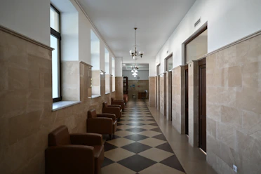 Empty hallway with chairs and doors