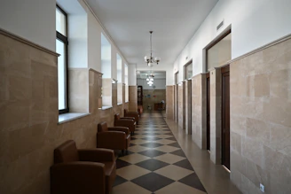 Empty hallway with chairs and doors