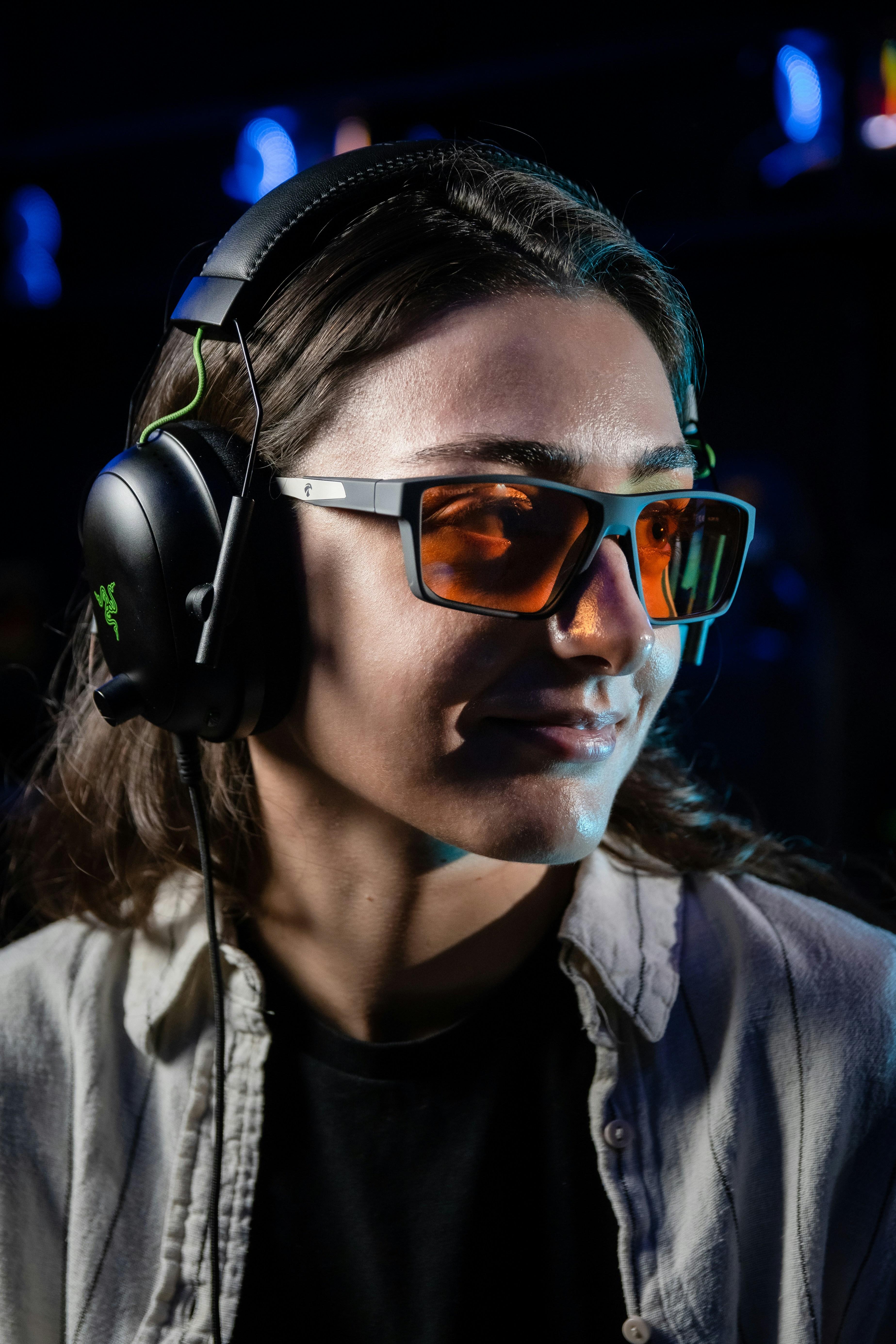 Young woman wearing gaming headset and orange glasses