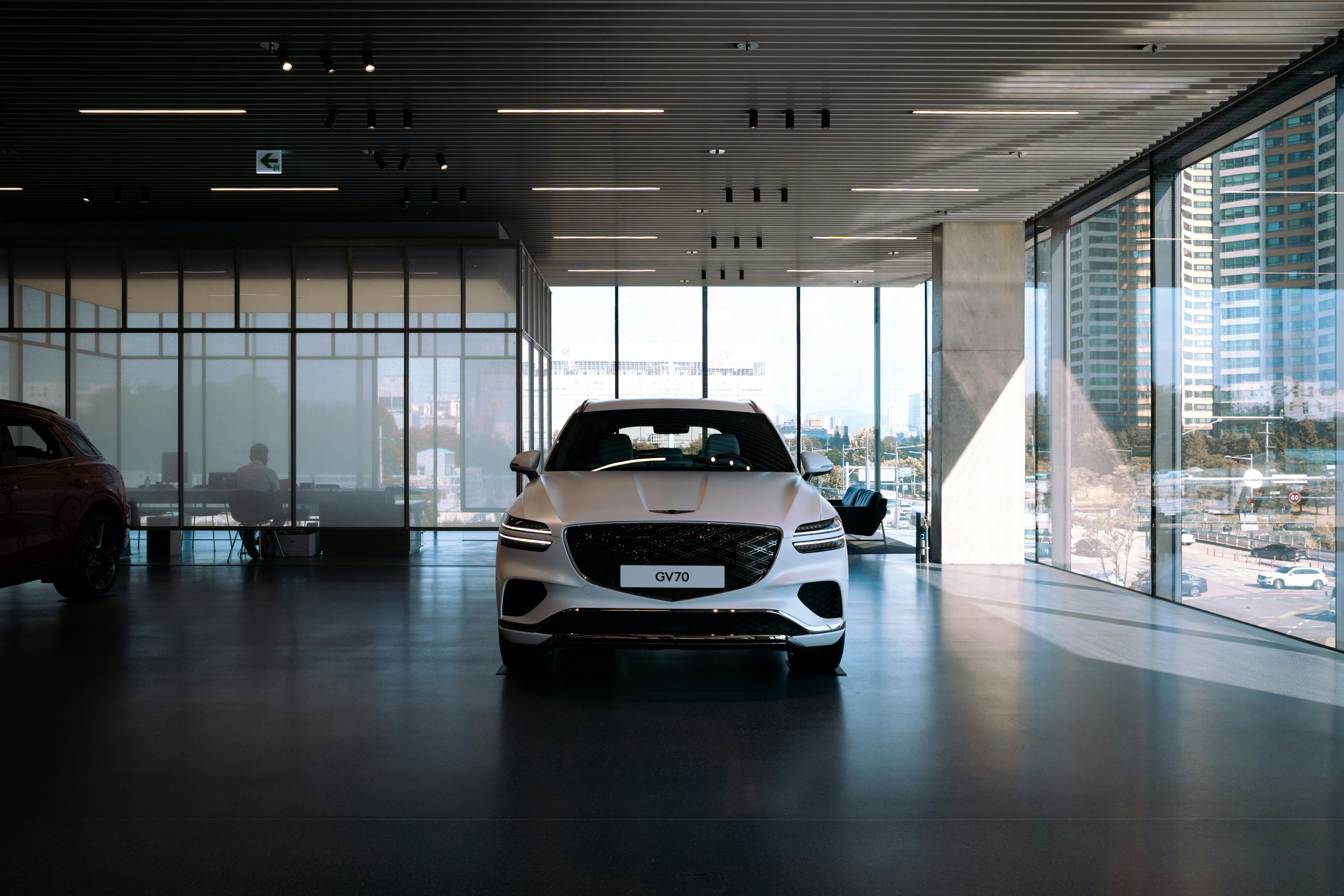 White luxury car inside a modern showroom
