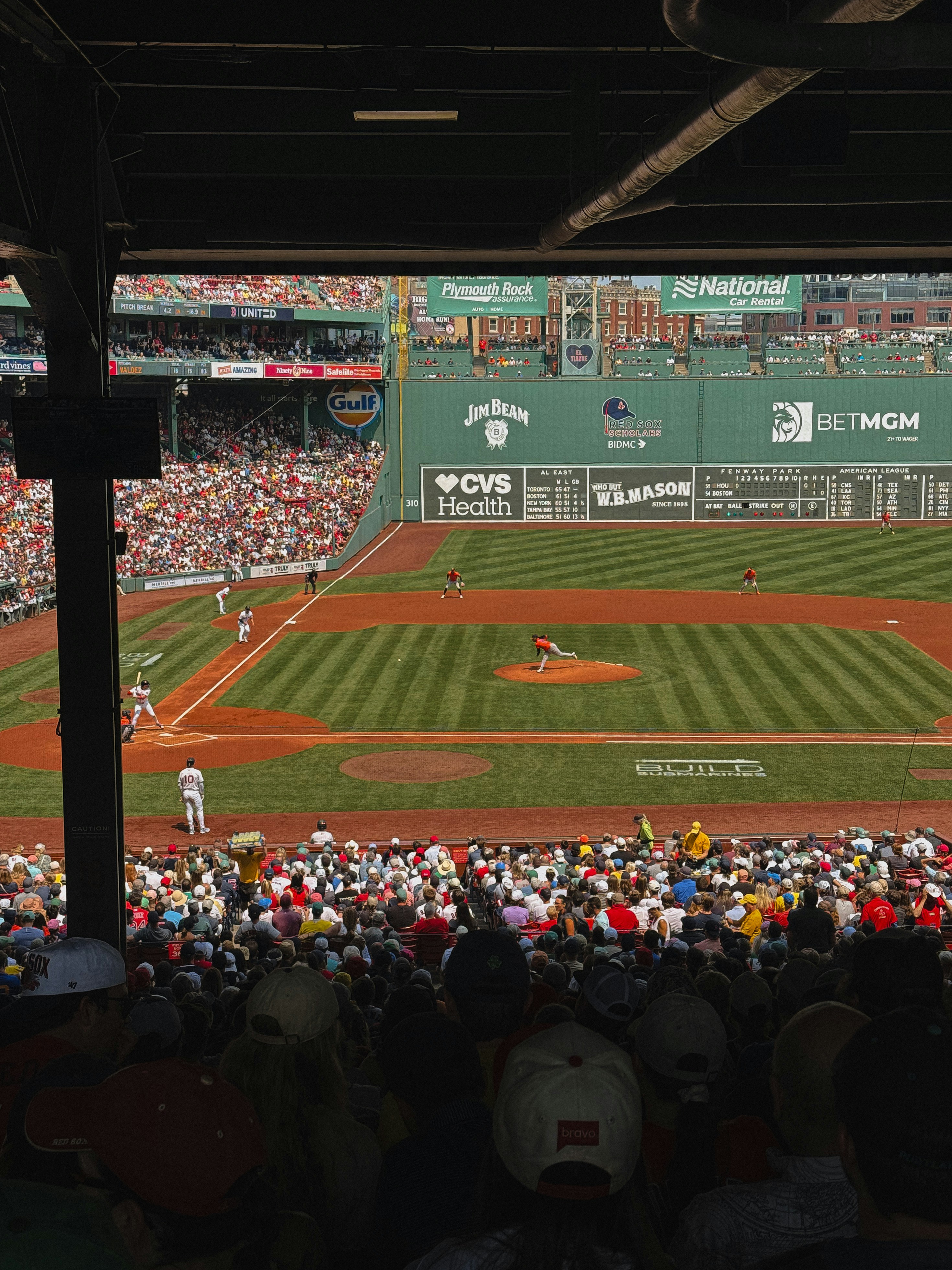 Baseball game in progress with spectators watching.