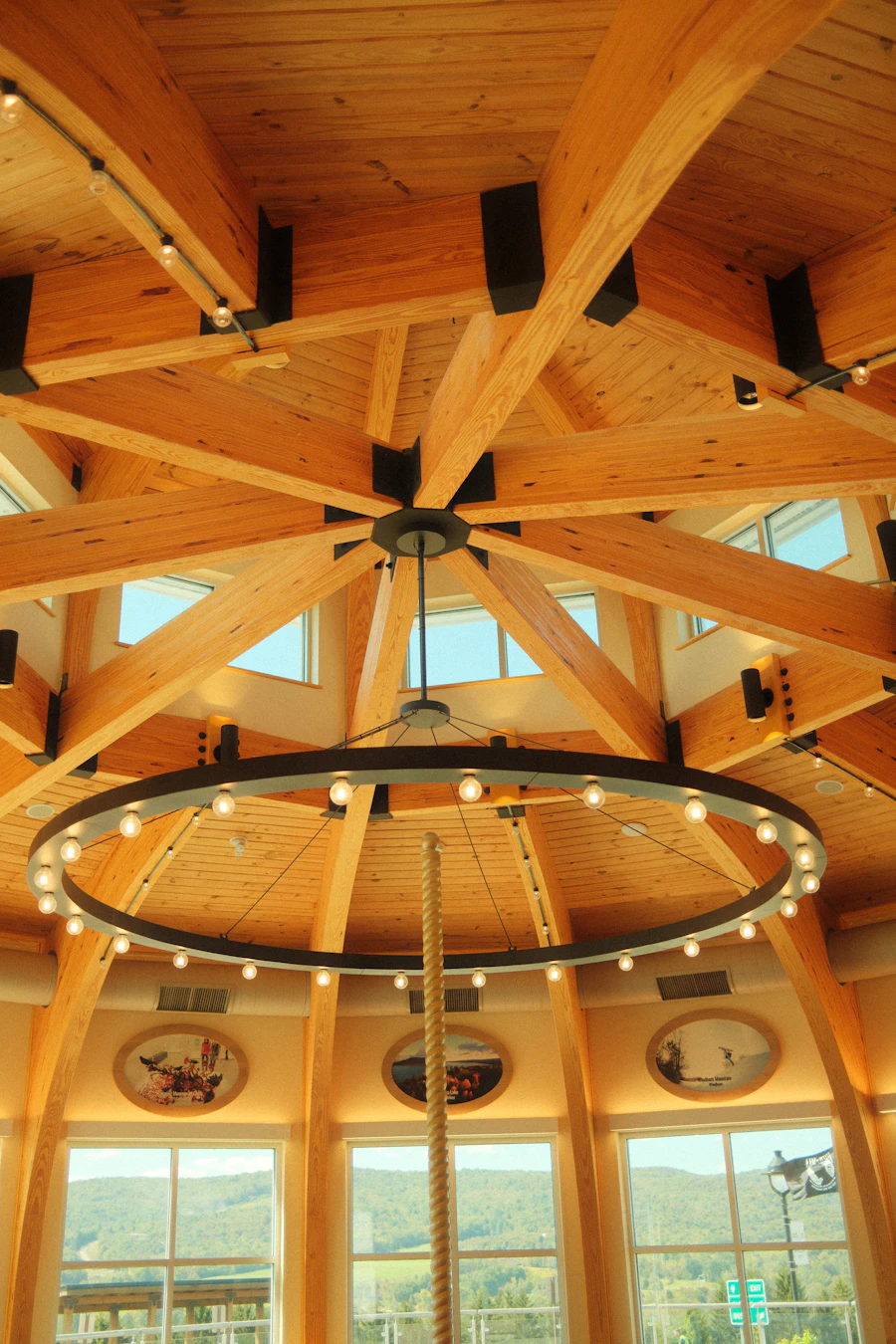 A timber-frame ceiling with a round chandelier