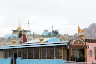 Colorful buildings on a rocky hillside under a cloudy sky