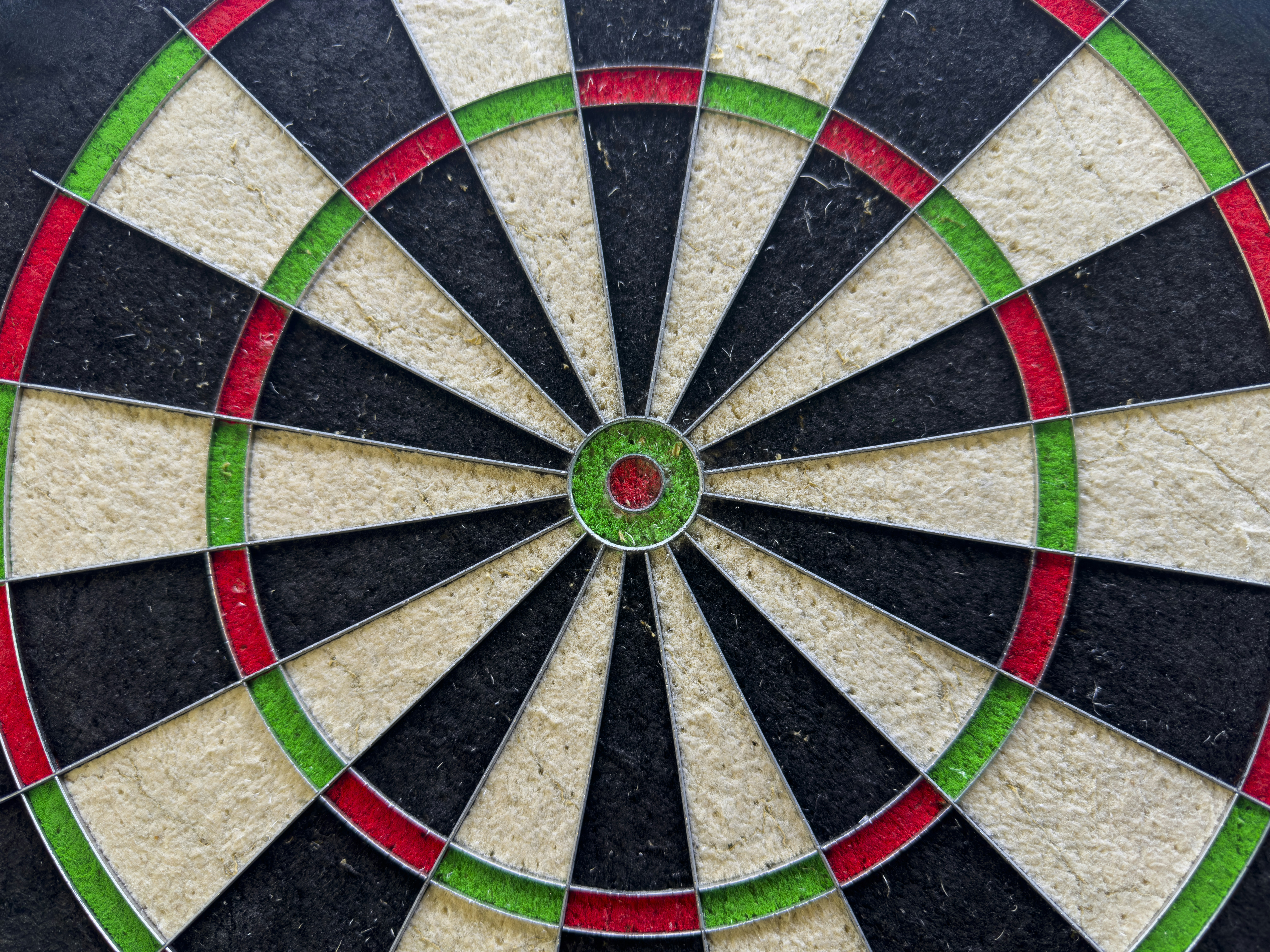 Close-up of a dartboard with colorful sections.