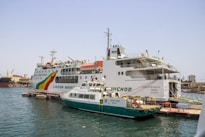 Large ferry docked with smaller boat alongside