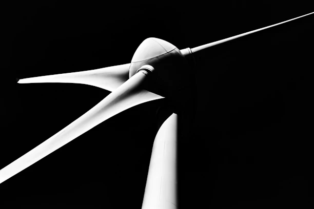 Close-up of a white wind turbine blade against black background