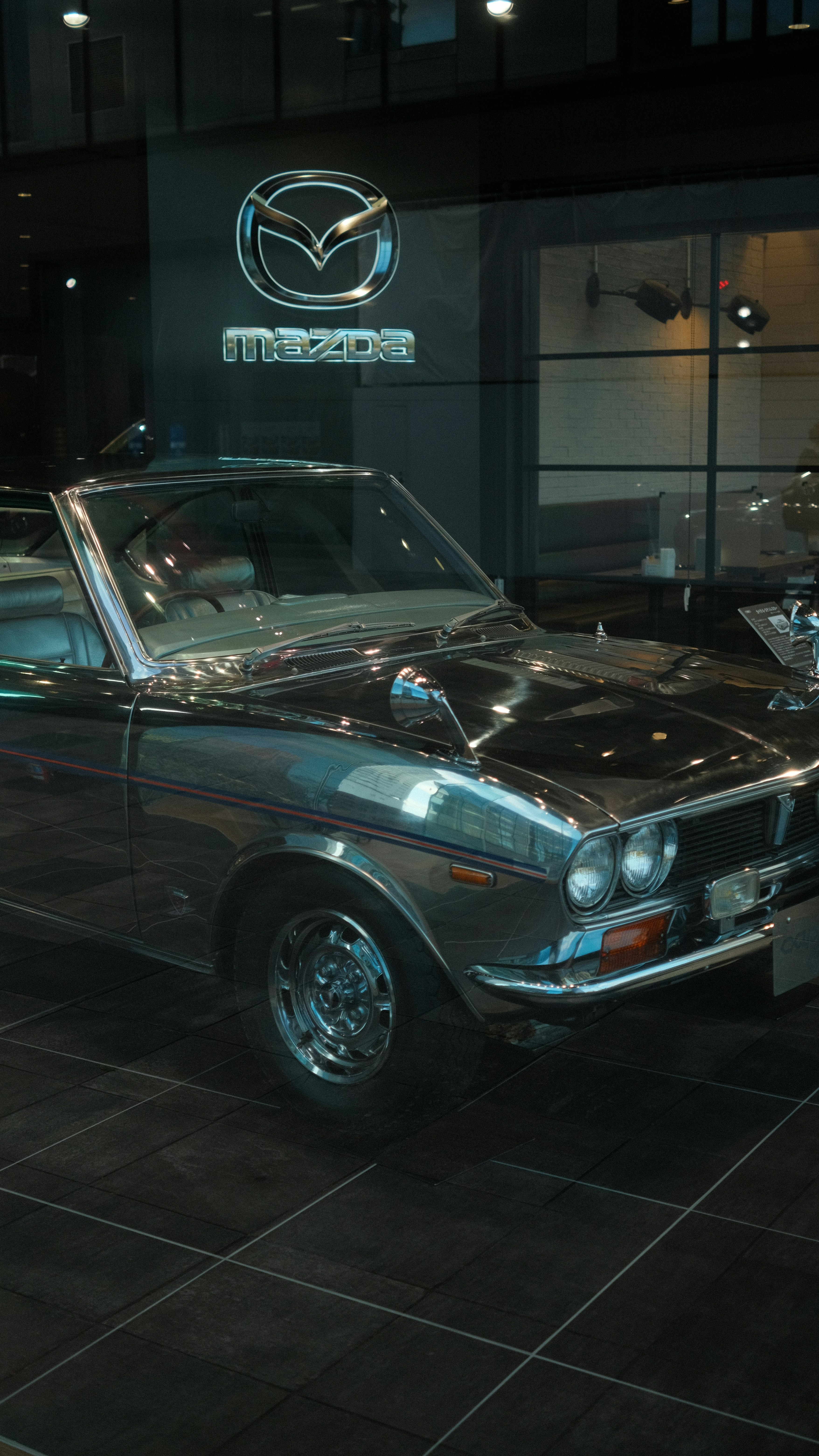 Classic mazda convertible displayed indoors.