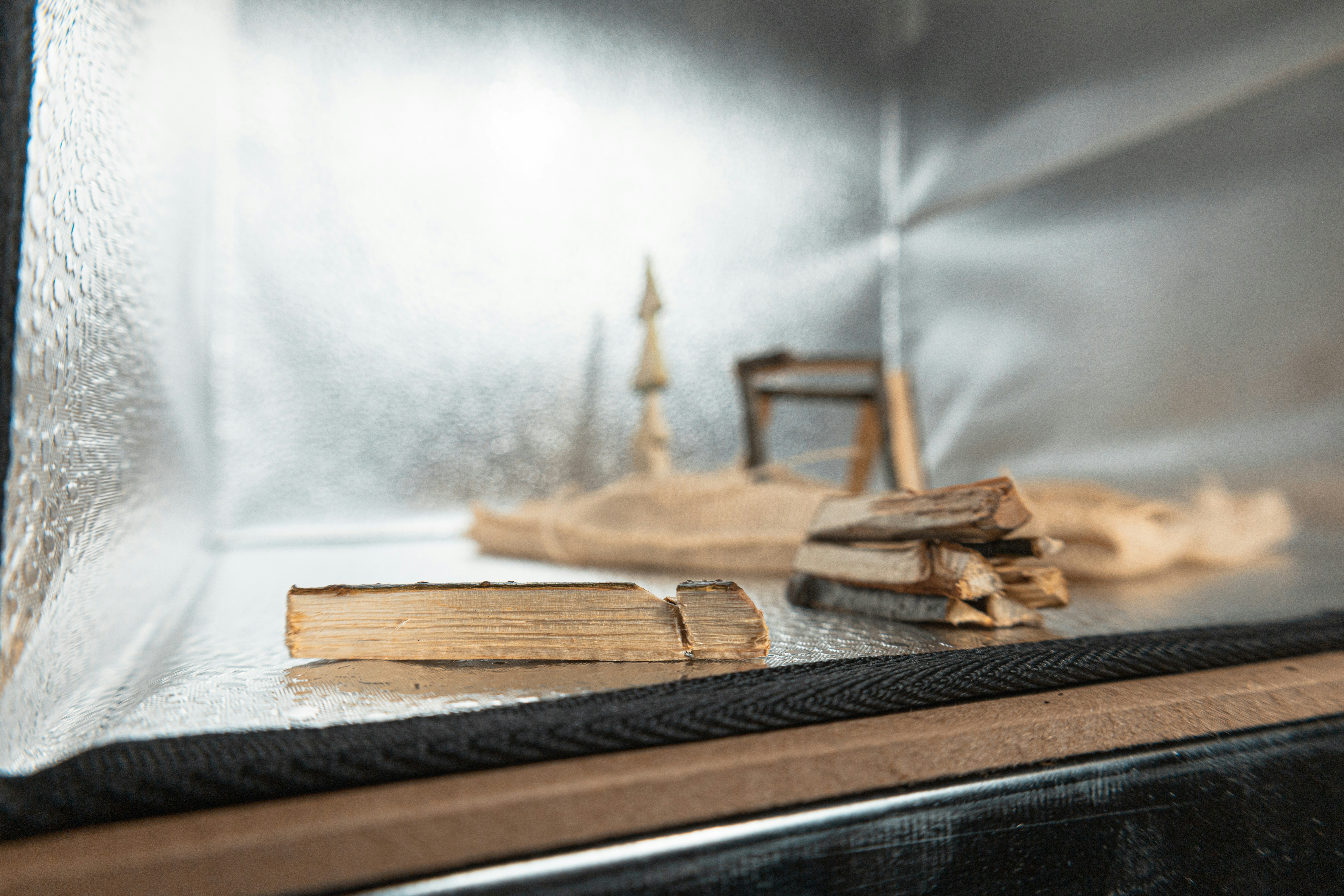 Pile of firewood in a diorama setting