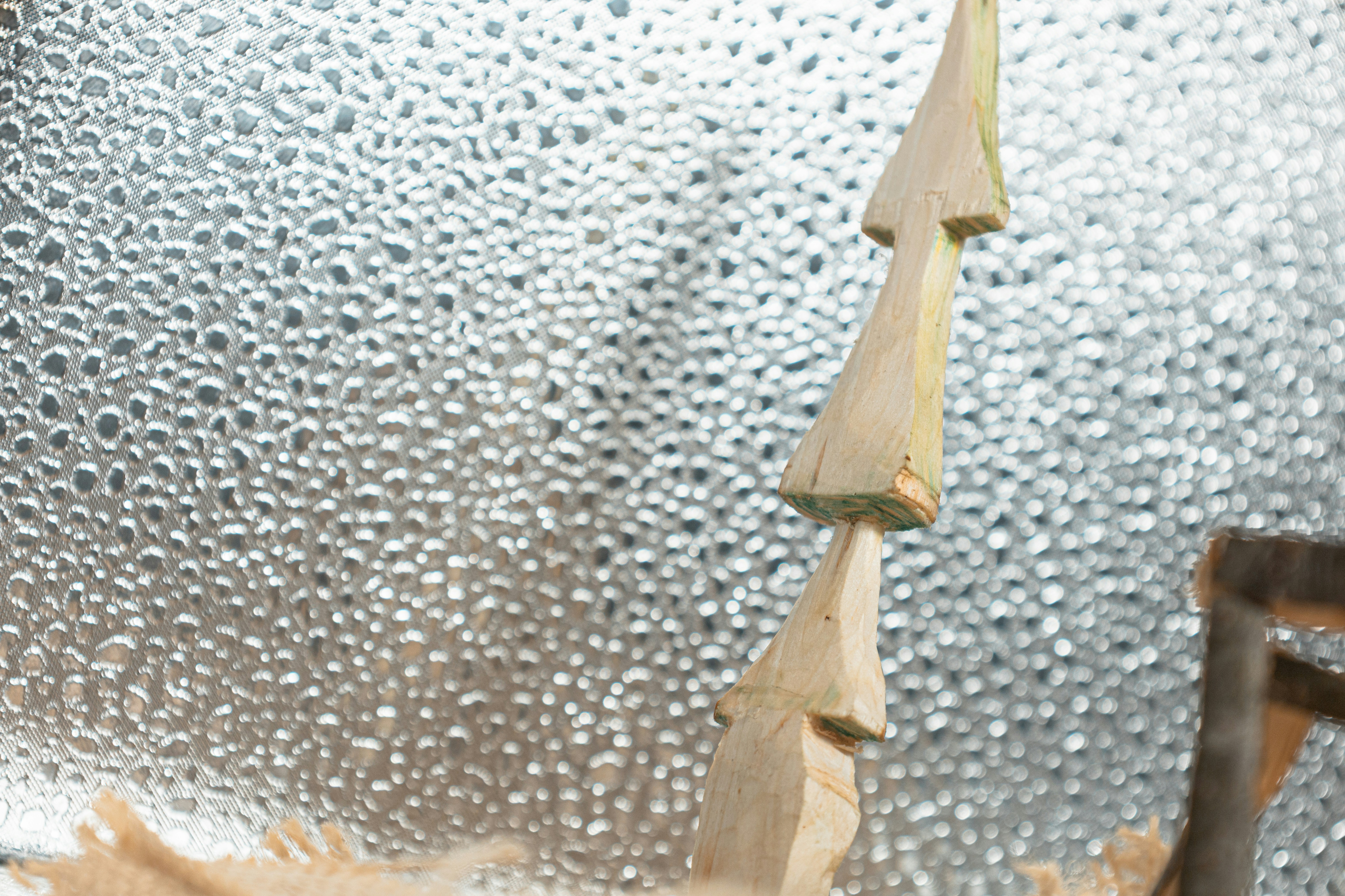 Two wooden trees against a textured background