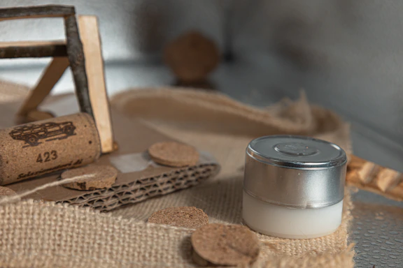 A cork, small bottle, and cardboard pieces of cardboard.
