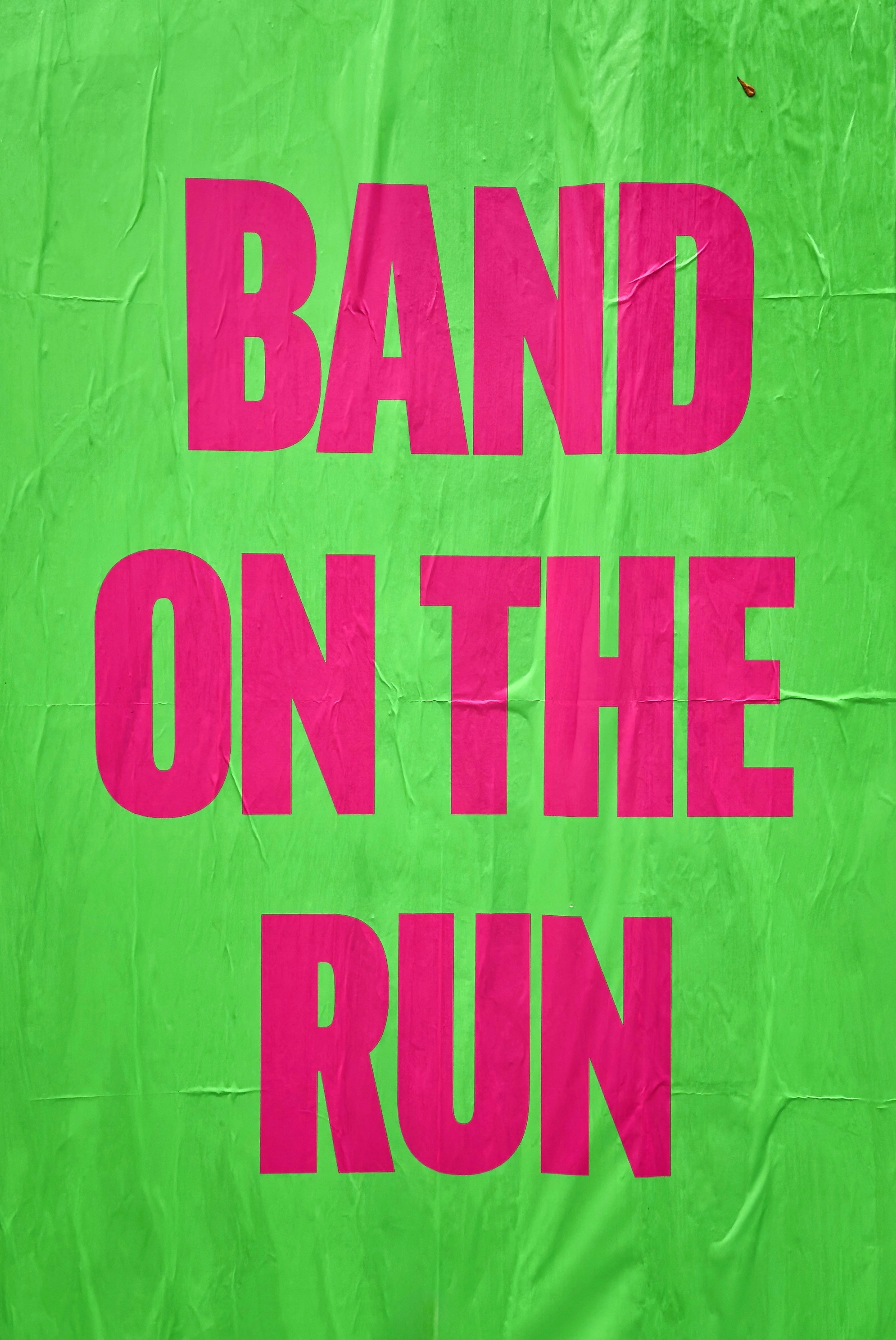 Pink text "band on the run" on green background