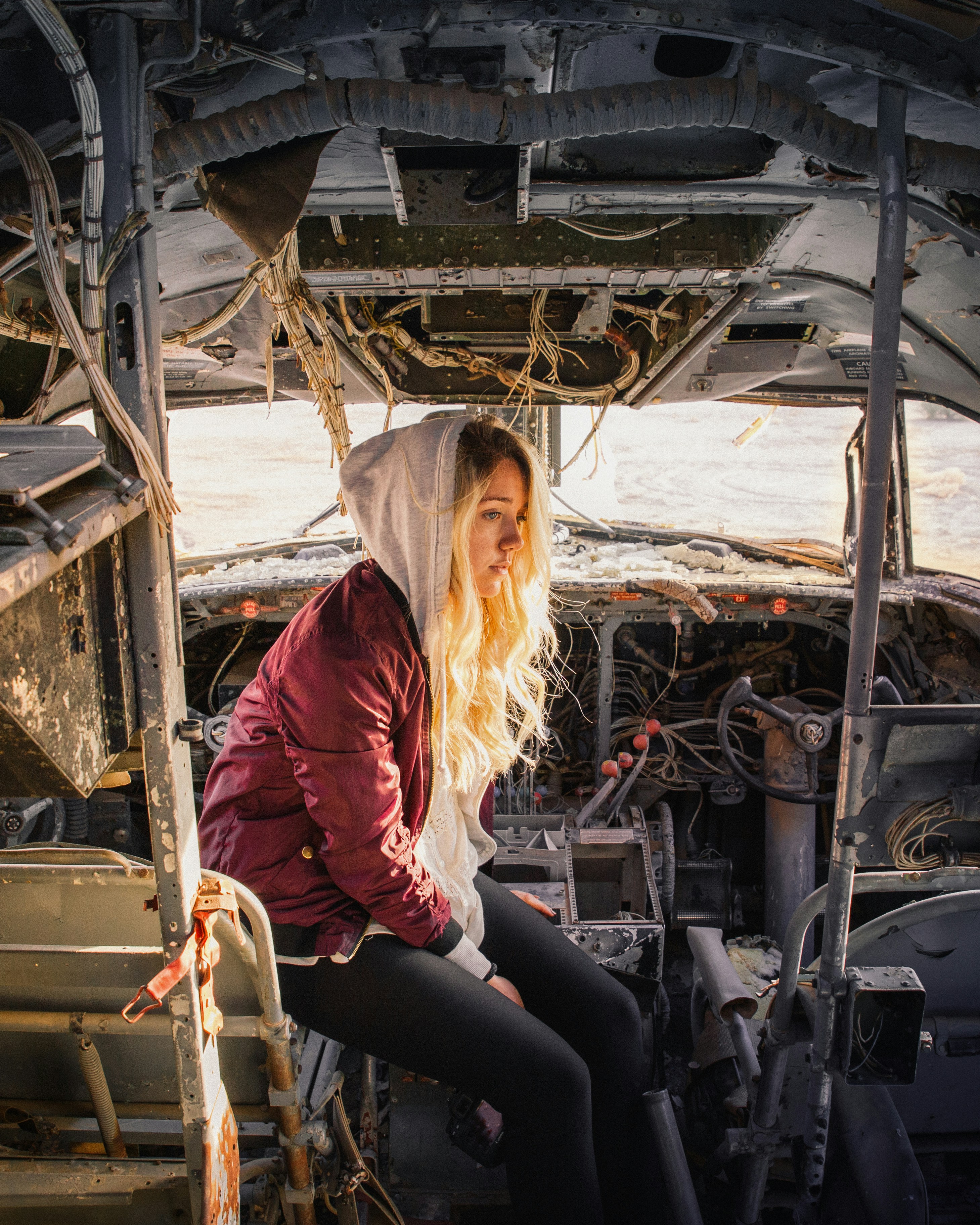 A visitor examining tractor parts at a salvage yard
