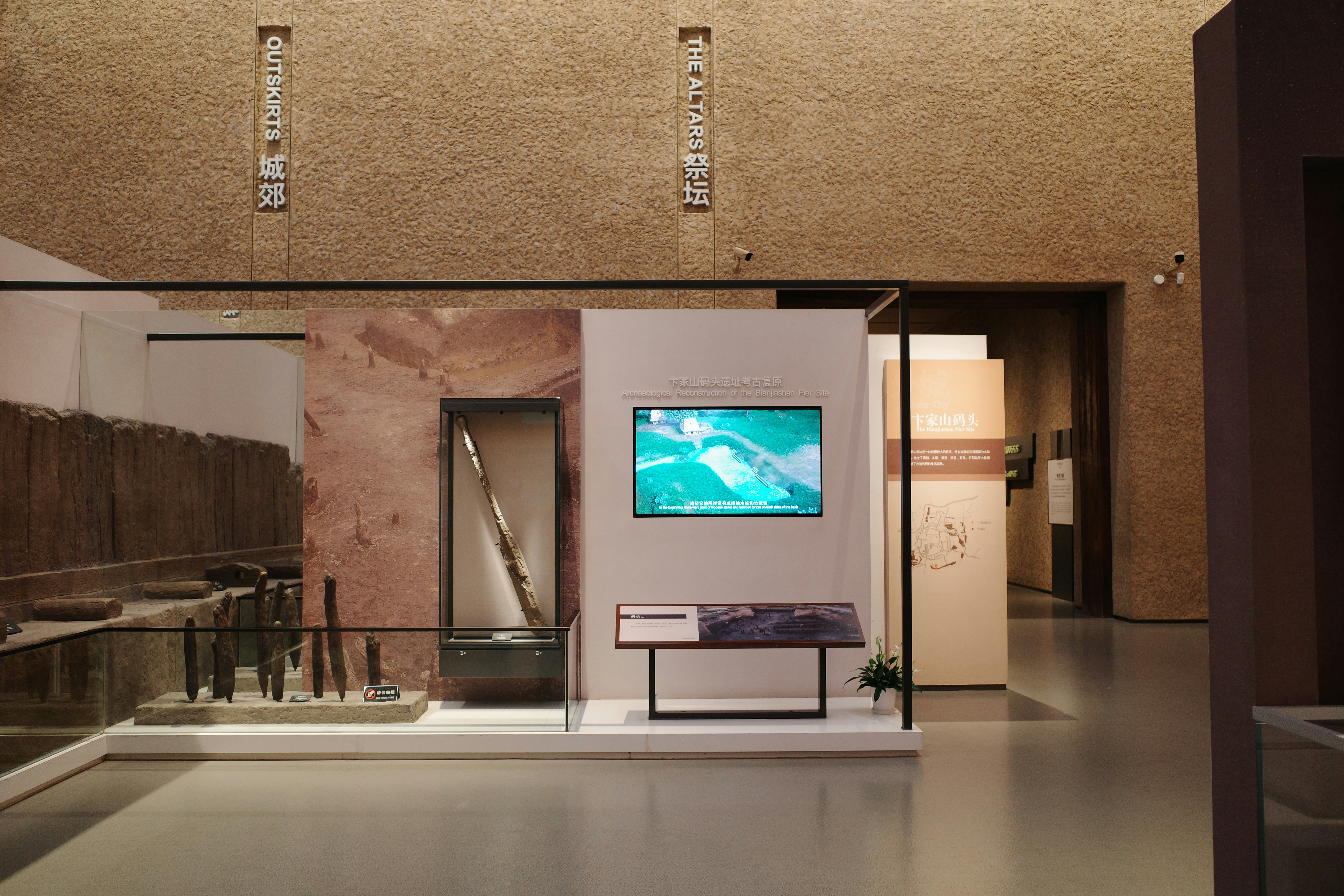 Museum exhibit displaying artifacts behind glass displays.