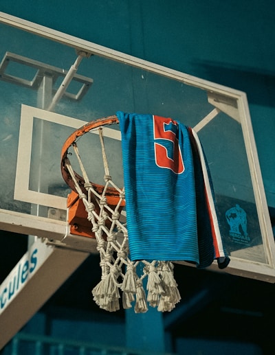 Blue towel with number 5 hangs on basketball hoop