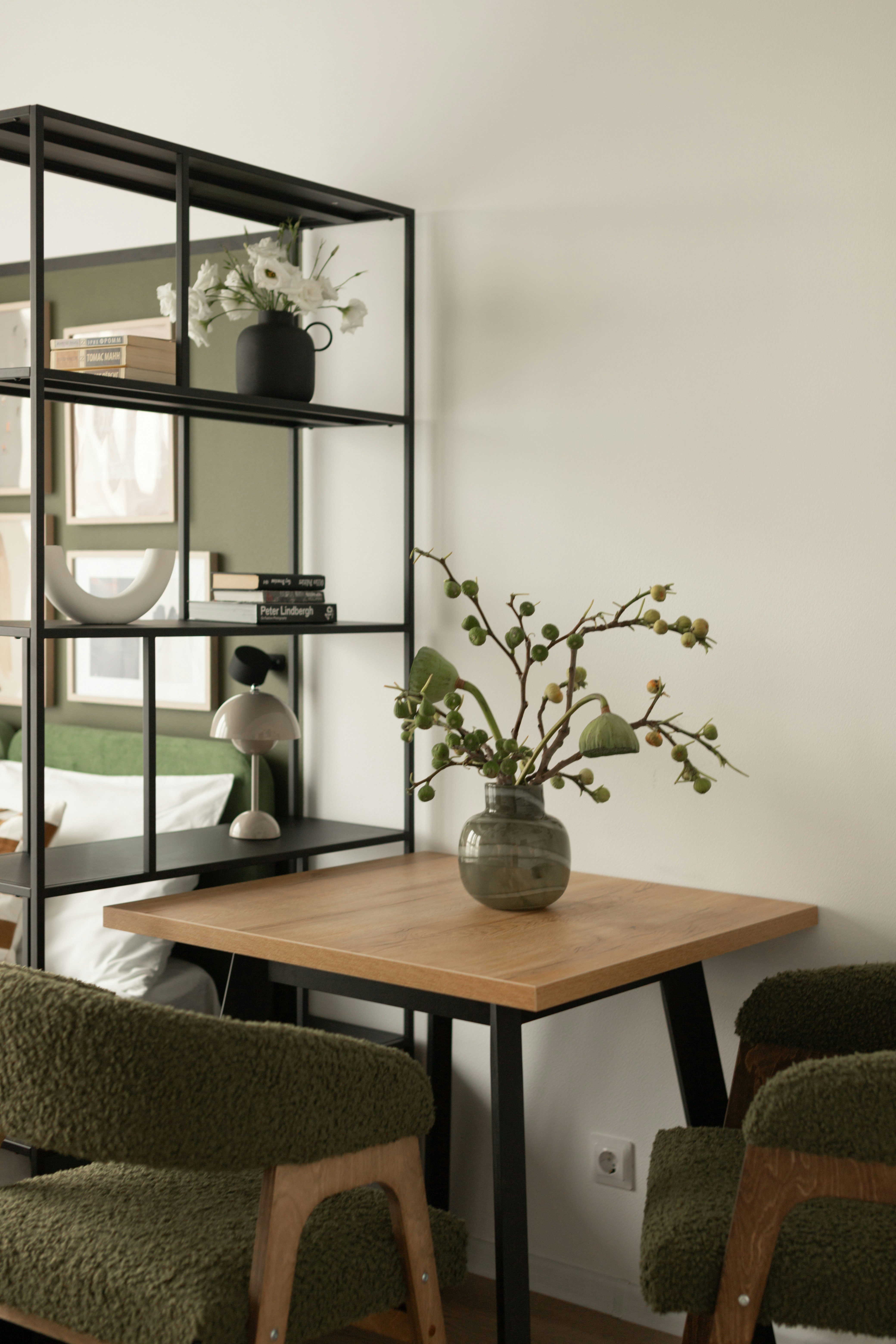Wooden table with chairs and decorative vase