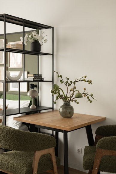 Wooden table with chairs and decorative vase