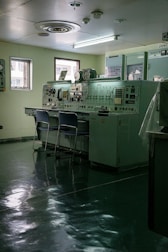 Control room with vintage equipment and chairs.