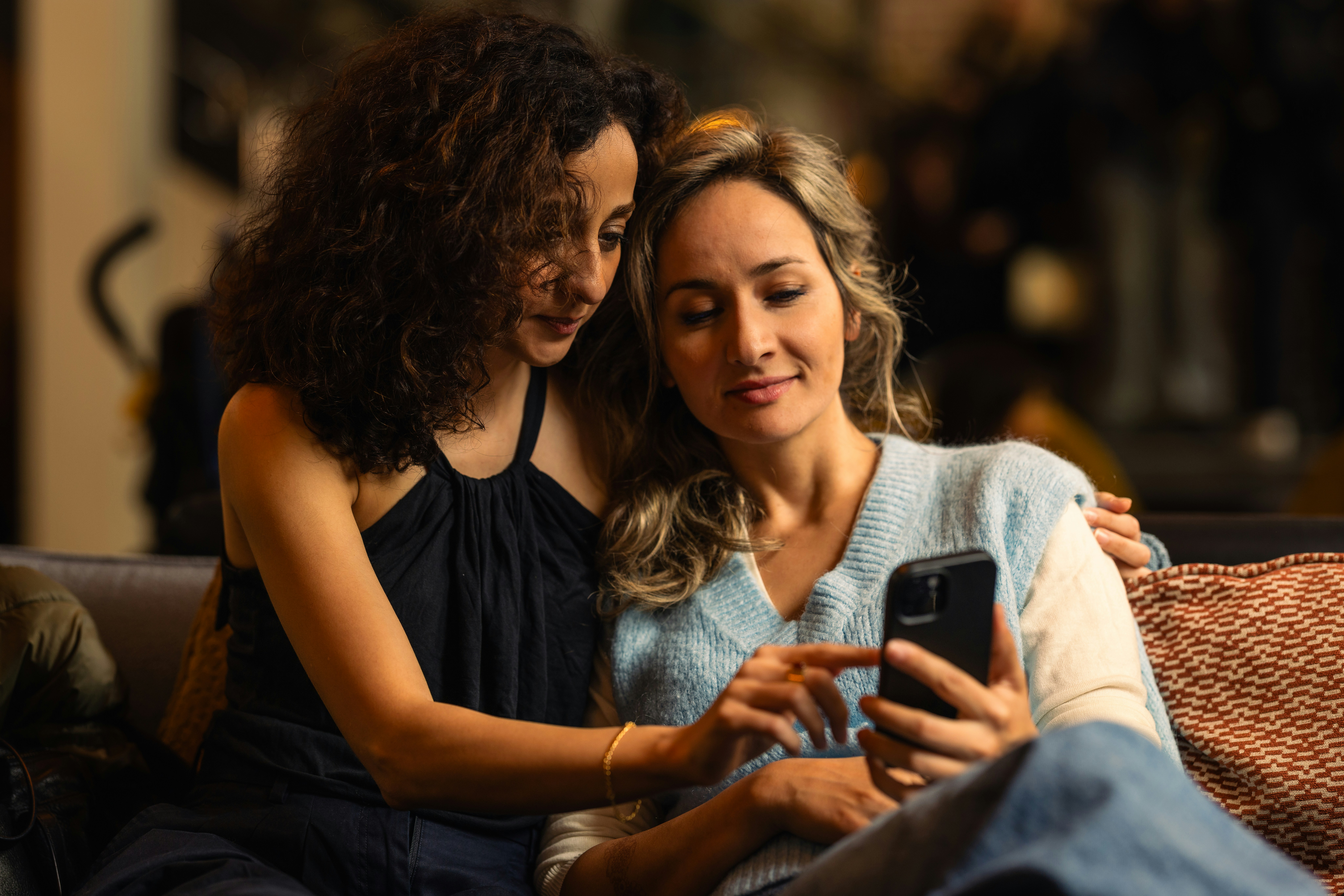 Two women looking at a smartphone together