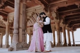 Couple posing in ornate historical architecture
