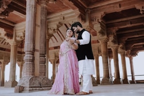 Couple posing in ornate historical architecture