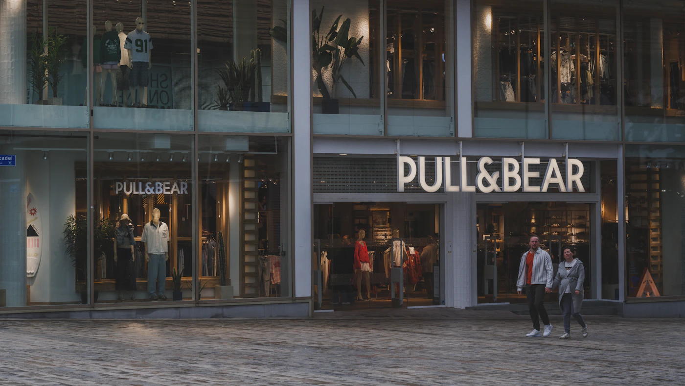Pedestrian shopping area with modern fashion storefronts representing Gloucester Premium Outlets