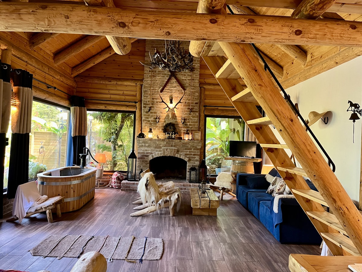 Cozy log cabin living room with fireplace and hot tub